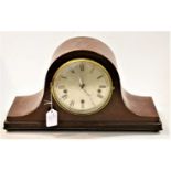 A 1920s mahogany cased mantel clock, having a silvered dial with Roman numerals and chiming