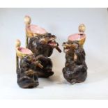 A graduated set of three majolica style jugs, each in the form of a bear with a bowl upon its