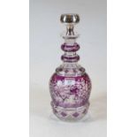 An amethyst overlaid and etched glass triple ring neck decanter, having white metal stopper, h.