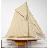 A large painted and lacquered wooden pond yacht, with full sales and rigging, named 'The Passing