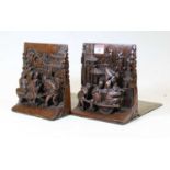 A pair of Chinese softwood book-ends, each carved with Chinese figures upon a rickshaw within a