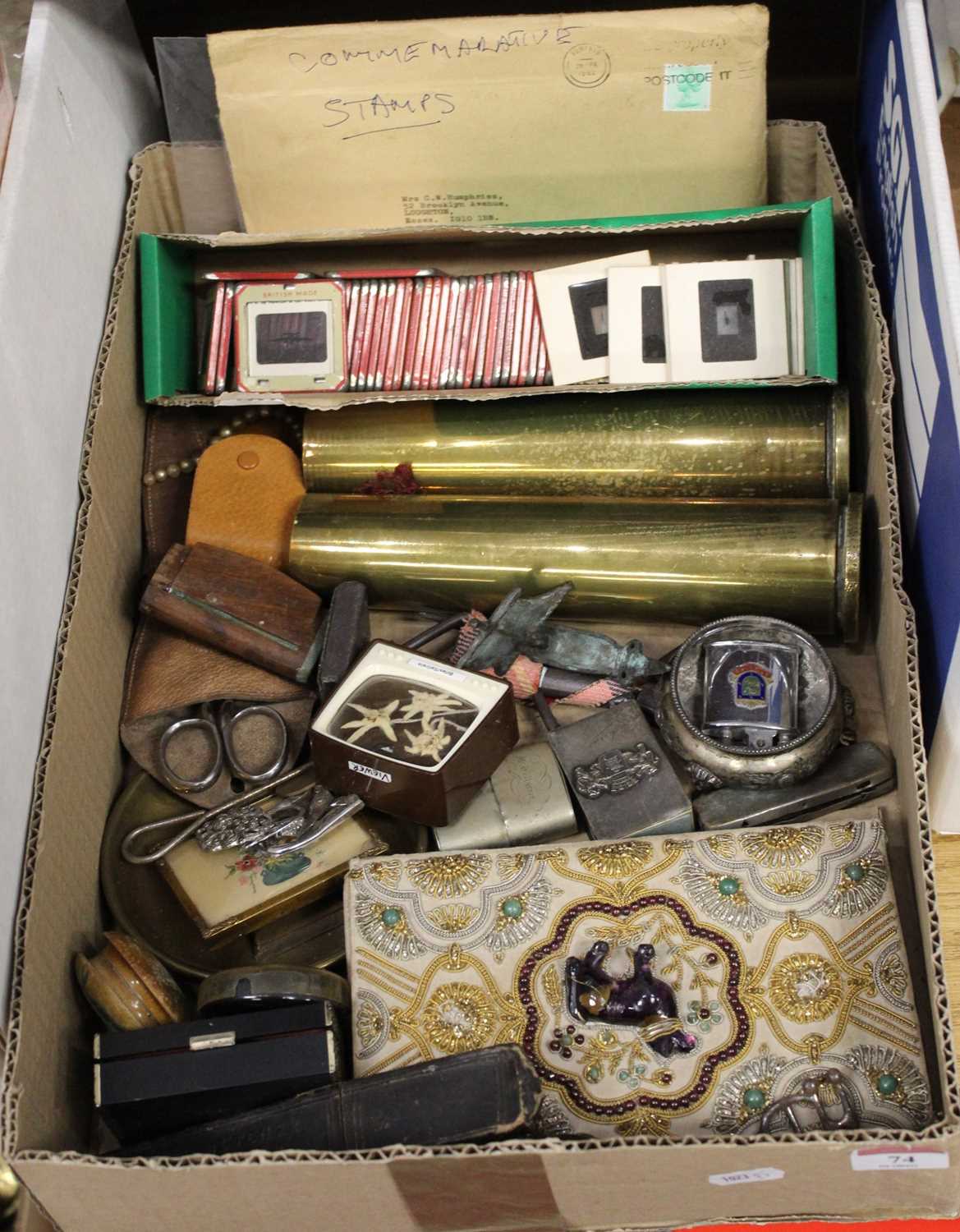 A box of miscellaneous items, to include a pair of brass shell cases, pocket cigarette lighters,