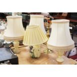 A set of three turned alabaster table lamps, each with a pleated silk shade, h.50cm (including