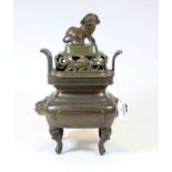 A Chinese bronze koro, the pierced cover surmounted by a mythical figure, the body of squat