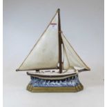 A reproduction cast iron door stop in the form of a yacht, h.30cm