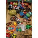 A box containing a collection of mainly tin plated children's toys