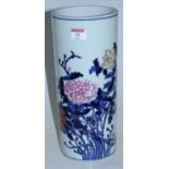 A Chinese stoneware vase of cylindrical form, enamel decorated with flowers and foliage having