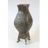 A modern Chinese bronzed metal vase, of square baluster form, having incised and relief figural