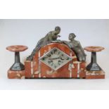 An Art Deco rouge and veined marble clock garniture, the central arched clock surmounted by