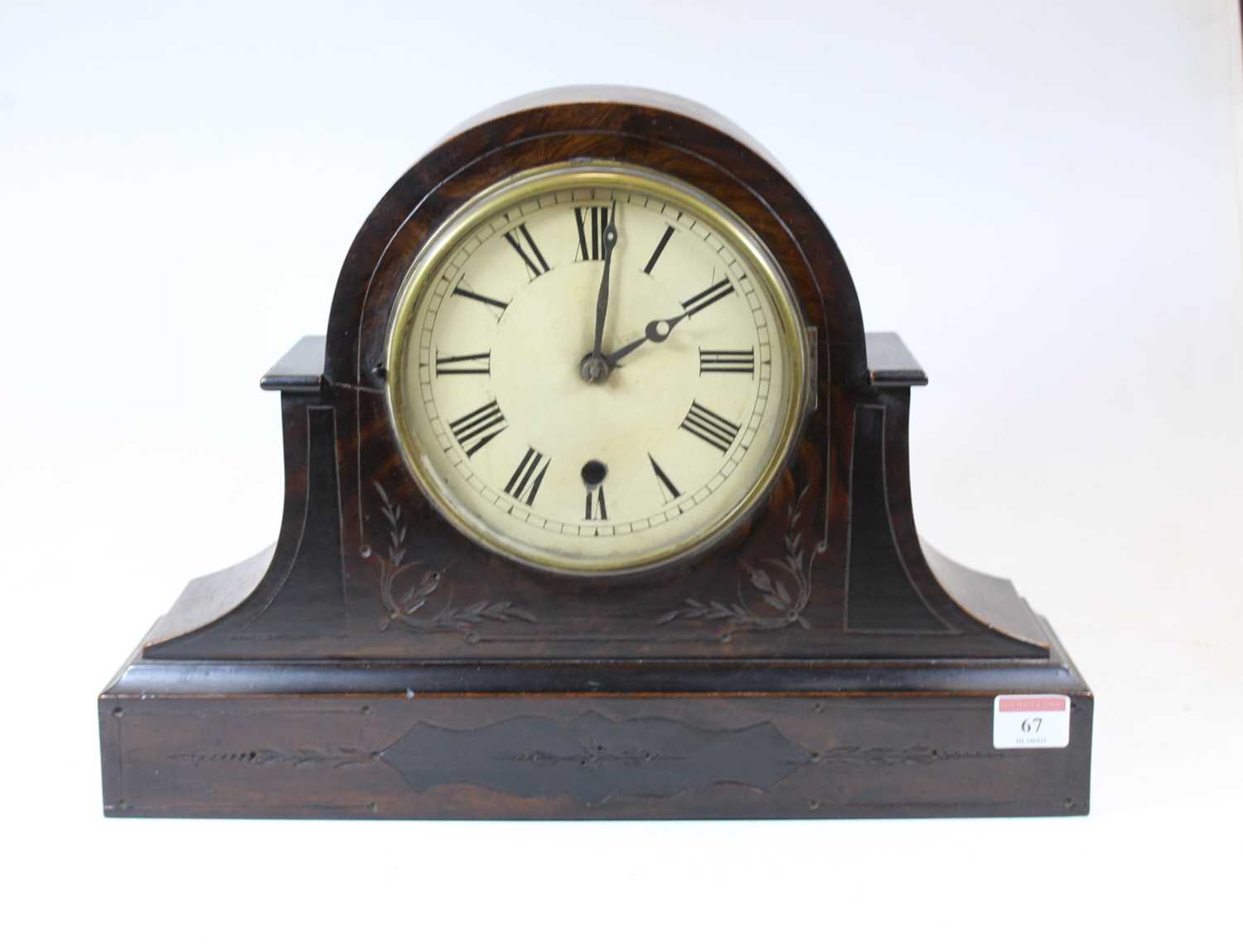 A late Victorian simulated walnut mantel clock, having an enamelled dial with Roman numerals and