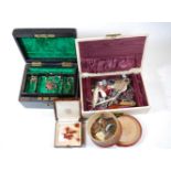 An early 20th century leather clad jewellery box and contents, to include paste set dress rings,