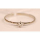 A 9ct white gold diamond solitaire ring, the claw set brilliant weighing approx 0.08 carats, 0.7g,