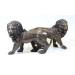 A pair of modern bronze figures of lions, each in standing pose, h.23cm