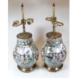 A pair of Chinese brass mounted table lamps, each of baluster form, enamel decorated with figures