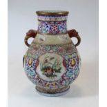 A Chinese porcelain vase, of baluster form, having twin elephant handles, enamel decorated with