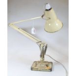 A cream painted anglepoise adjustable desk lamp, on a stepped square base