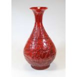 A modern Chinese red glazed porcelain vase, having a flared rim to a slender neck and bulbous