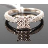 A modern 9ct yellow and white gold diamond dress ring, the square head set with nine small