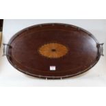 An early 20th century mahogany tray, of oval form, the centre with satinwood fan inlay, having