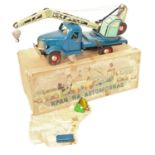 A Hungarian tinplate and clockwork model of a four wheel crane, finished in dark blue with two-