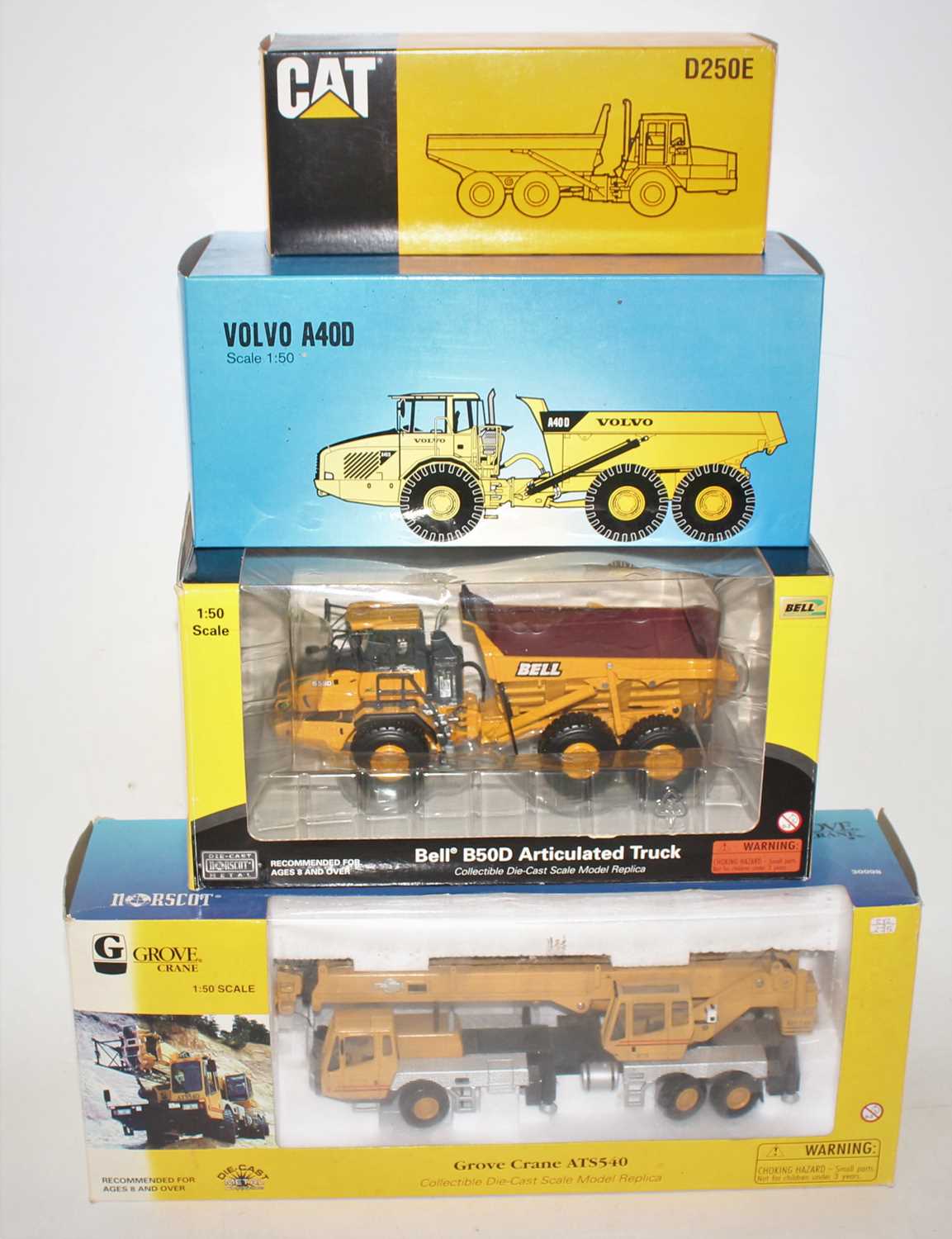 Four various boxed mixed manufacturers 1/50 scale construction vehicles to include a Norscot Grove