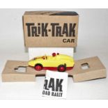 A Spot-On Models Trik-Trak car, comprising of yellow and red plastic body racing car with racing No.