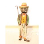 An early 20th century lead hollow cast and tin model of a black cat dressed in gentleman's outfit to