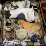 A box containing a collection of various ceramic and composition models of cats and dogs