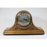 An early 20th century oak cased 8-day mantel clock, the silvered dial showing Arabic numerals,