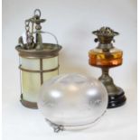 An early 20th century brass oil lamp, with amber tinted glass font, h.31cm; together with a 20th