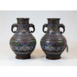 A pair of Chinese cloisonne enamel decorated vases, the flared rim above a cylindrical neck