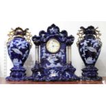 A 20th century blue and gilt decorated pottery clock garniture, of architectural form, having quartz