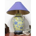 A 20th century Chinese porcelain vase, with blue lotus decoration on a yellow ground, converted into