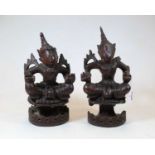 A pair of 20th century Eastern carved hardwood figures, each shown in lotus pose, h.30cm