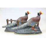 Two 20th century cast iron door-stops, each in the form of a pheasant, h.26cm