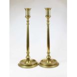 A pair of large Victorian brass candlesticks, each standing on a circular foot, h.46cm