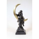 After Claire Jeanne Roberte Colinet - a bronze of Pierrot, shown climbing a quatre-moon, standing on