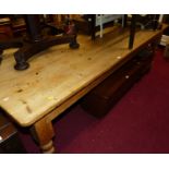 A modern pine round cornered long farmhouse kitchen table, raised on turned supports, length 245cm