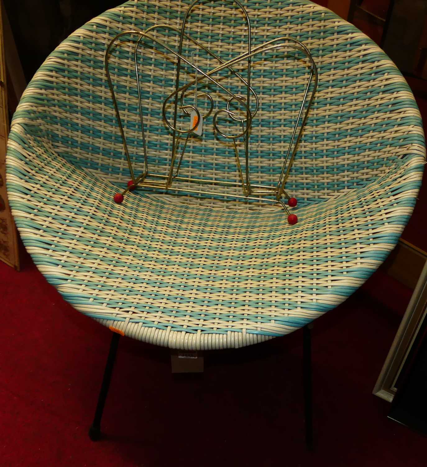 A 1950s wicker basket chair on an iron base, together with a metal magazine rack (2)