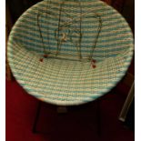 A 1950s wicker basket chair on an iron base, together with a metal magazine rack (2)