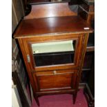 An Edwardian mahogany and satinwood strung ledgeback music cabinet, the glazed upper door over