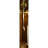 An early 20th century polished brass paraffin lamp, having a floral milk glass shade, height 150cm