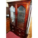 A reproduction cherry wood china display cabinet, with twin glazed doors