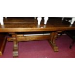 A plank top oak refectory type coffee table, having cleated ends, length 127cm