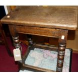 A 17th century style joined oak joint stool, the top with exposed nail heads, raised on bobbin