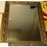 A reproduction gilt composition framed and bevelled wall mirror, 77x107cm