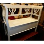 A baby blue painted pine two-seat settle, having typical hinged box seat base, width 120cm