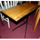 A late Victorian oak and black painted cast iron telescopic reading table