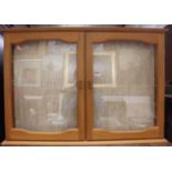 Two contemporary beech double door glazed hanging collectors' display cabinets, with sundry glass