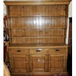 A Victorian pine freestanding kitchen dresser, having graduated three-tier plate rack over base